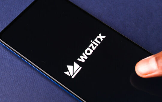 The WazirX logo on a phone